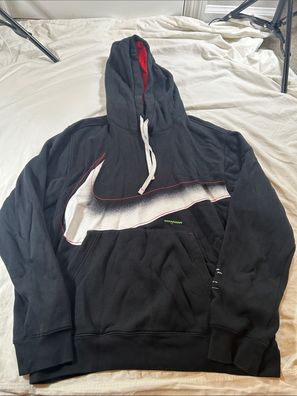 Nike Black Hoodie with Large White Swoosh and Red Hood Lining